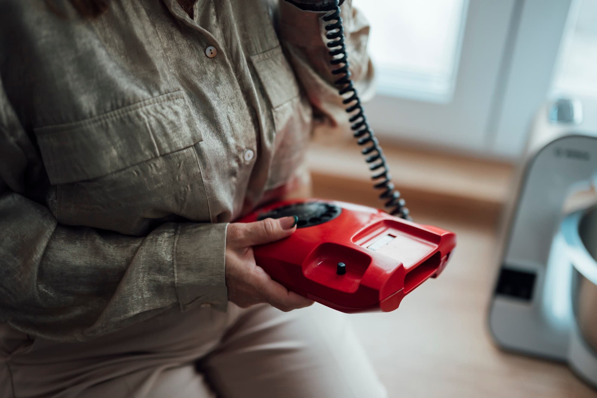 Woman talking on the phone in a bright office